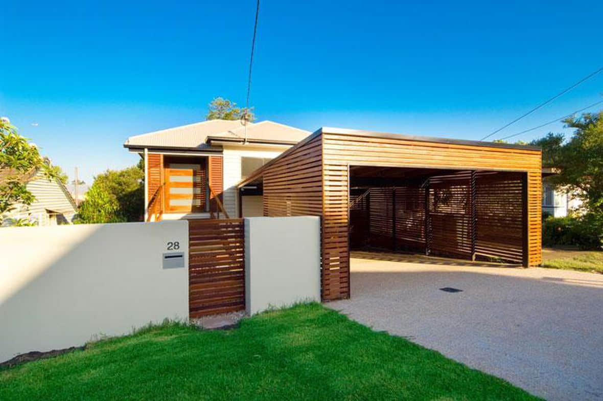 A wooden slat garage and driveway attached to home
