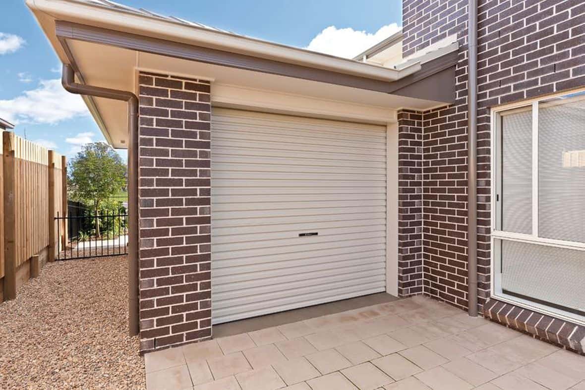 integrated brick garage attached to matching brick house